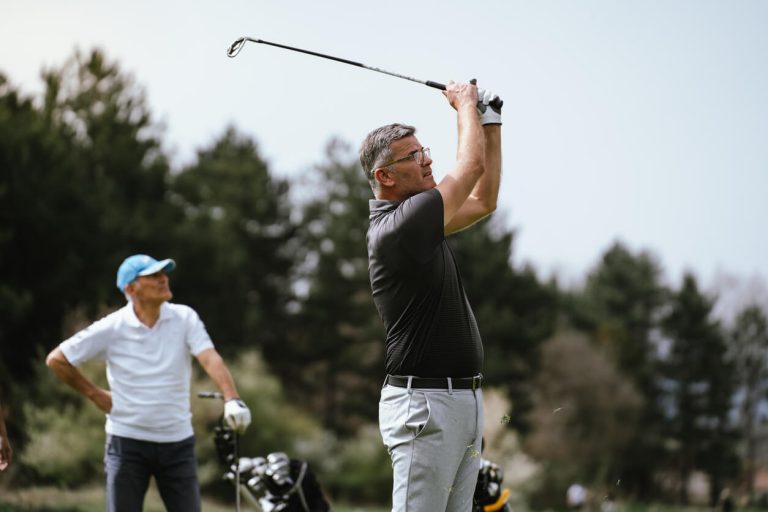 older-man-swinging-golf-club